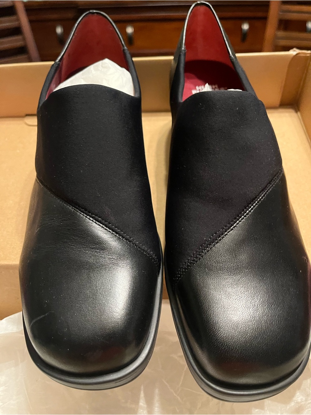 Women’s black leather stretch, hush puppy shoes.